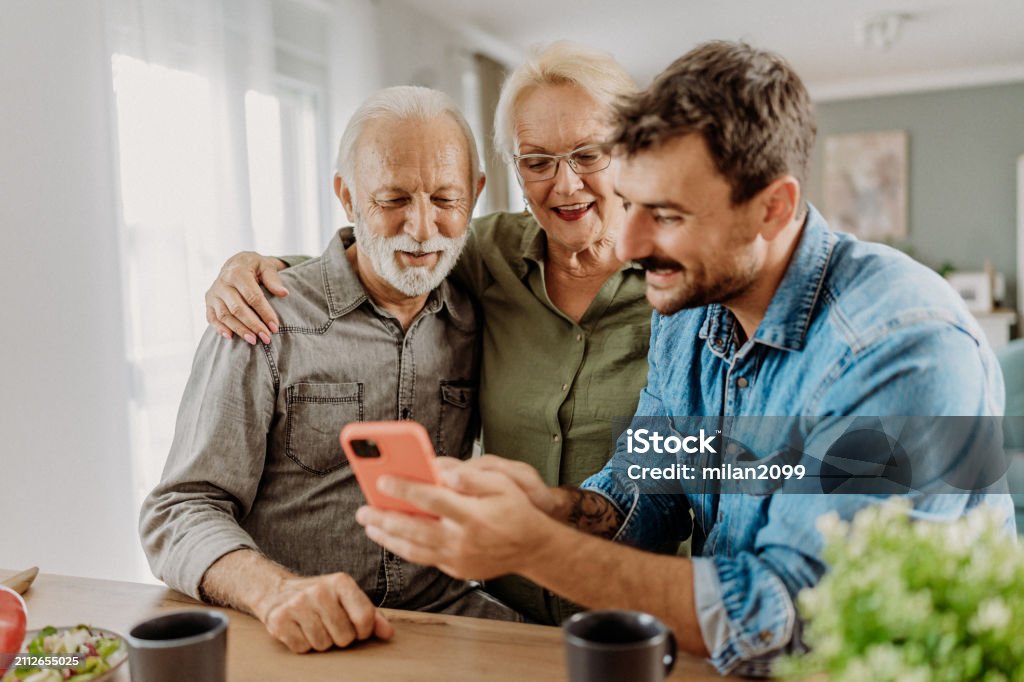 Man demonstrating mobile to seniors