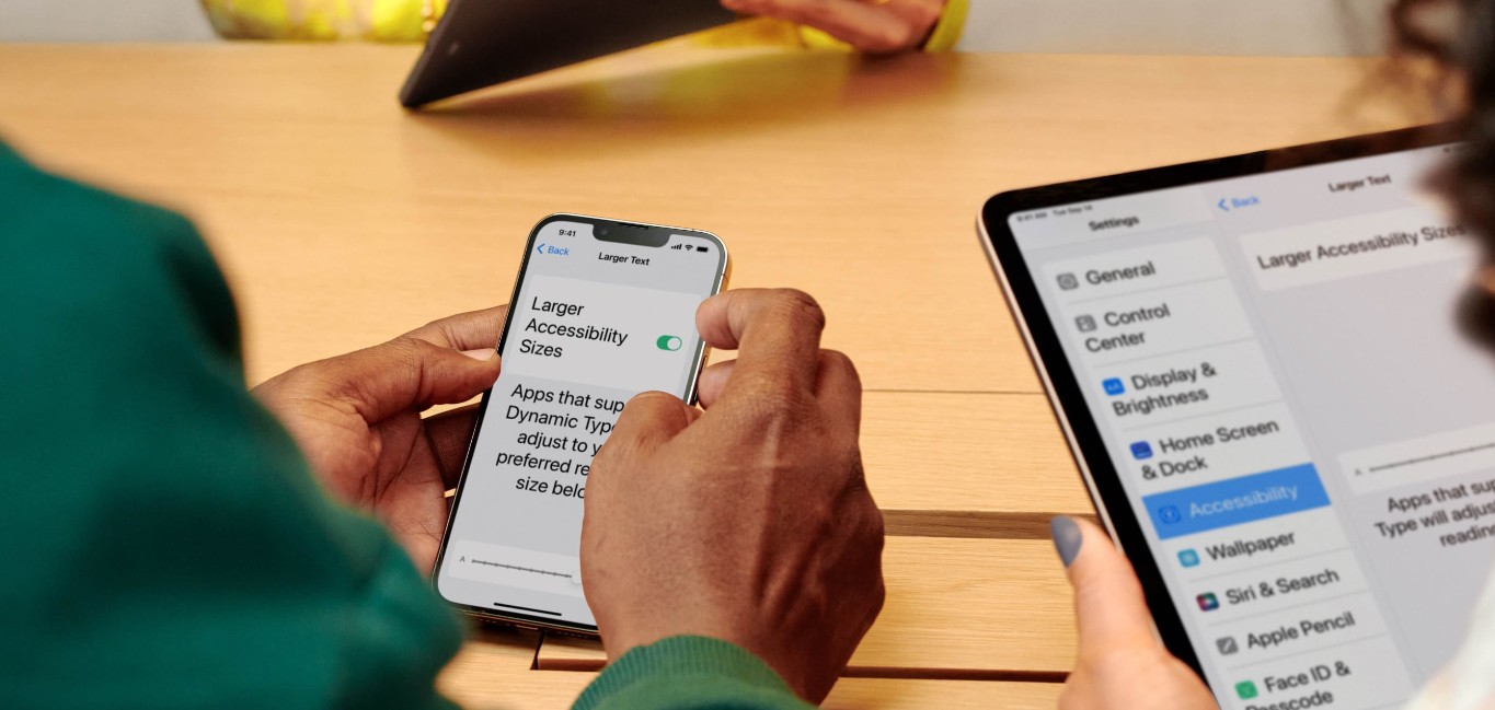 Photo of people using their hands to access Vision Accessibility Features on an iPhone and iPad
