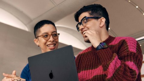 Two people using Apple VoiceOver on a laptop.